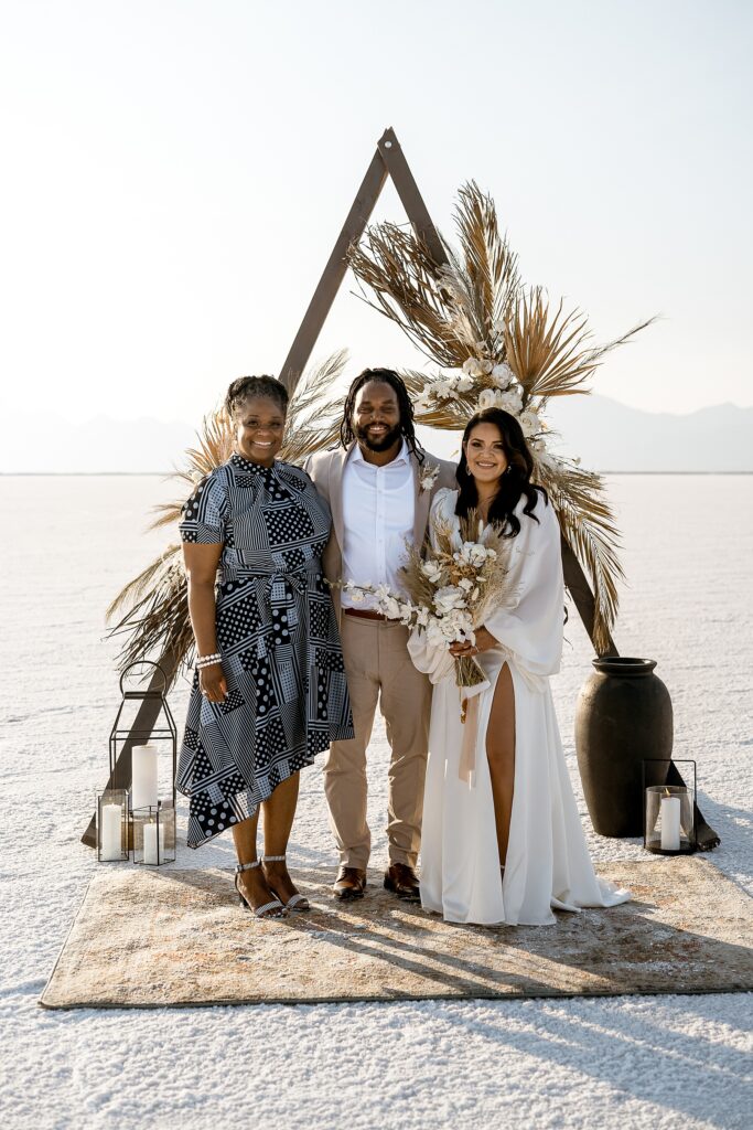 Utah elopement photographer captures bride and groom standing with groom's mother after wedding ceremony