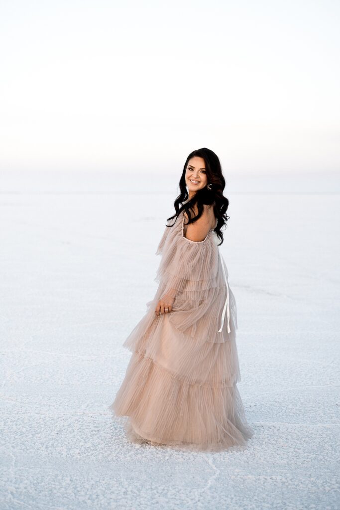 Utah elopement photographer captures bride wearing blush Salt Gowns dress after Salt Flats elopement