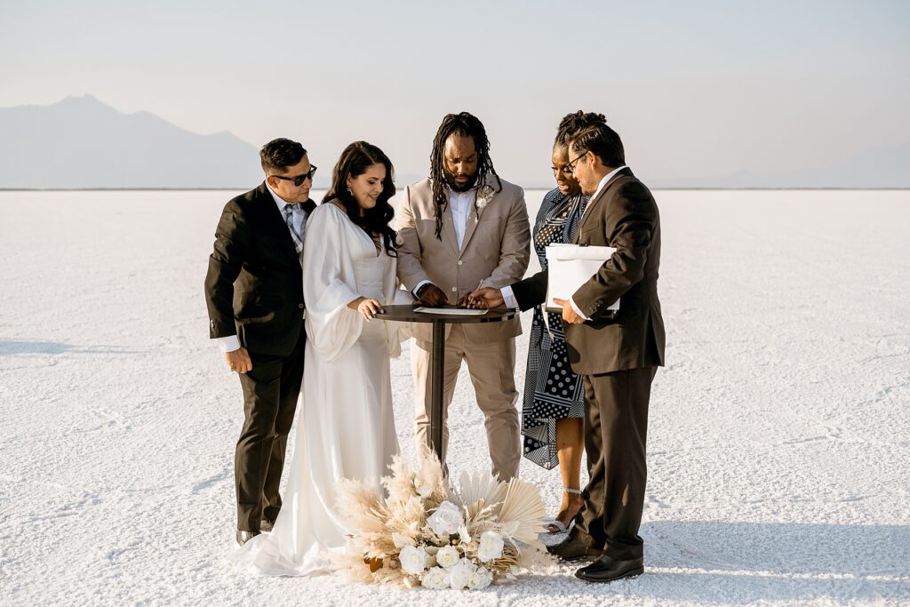 Utah elopement photographer captures bride and groom signing wedding certificate
