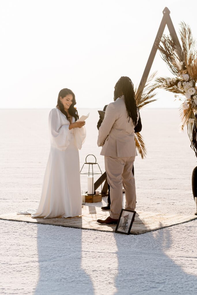 Utah elopement photographer captures bride reading vows during wedding ceremony