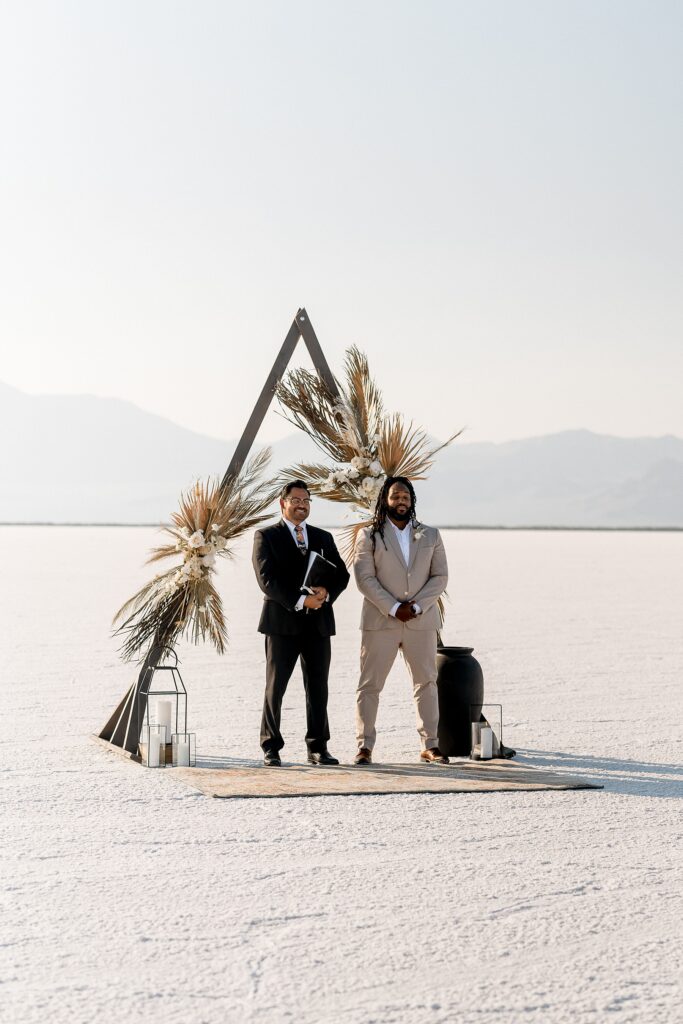 Utah elopement photographer captures groom standing at alter waiting for bride