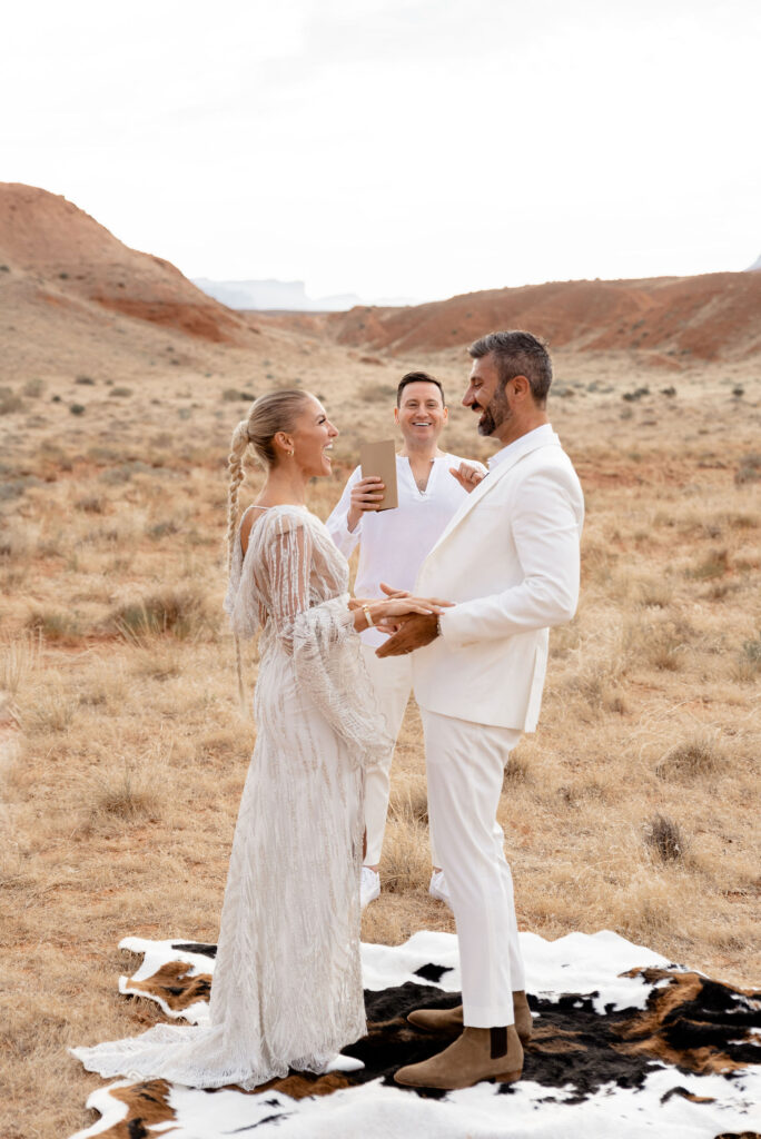 Moab elopement photographer captures bride and groom laughing and celebrating after ceremony