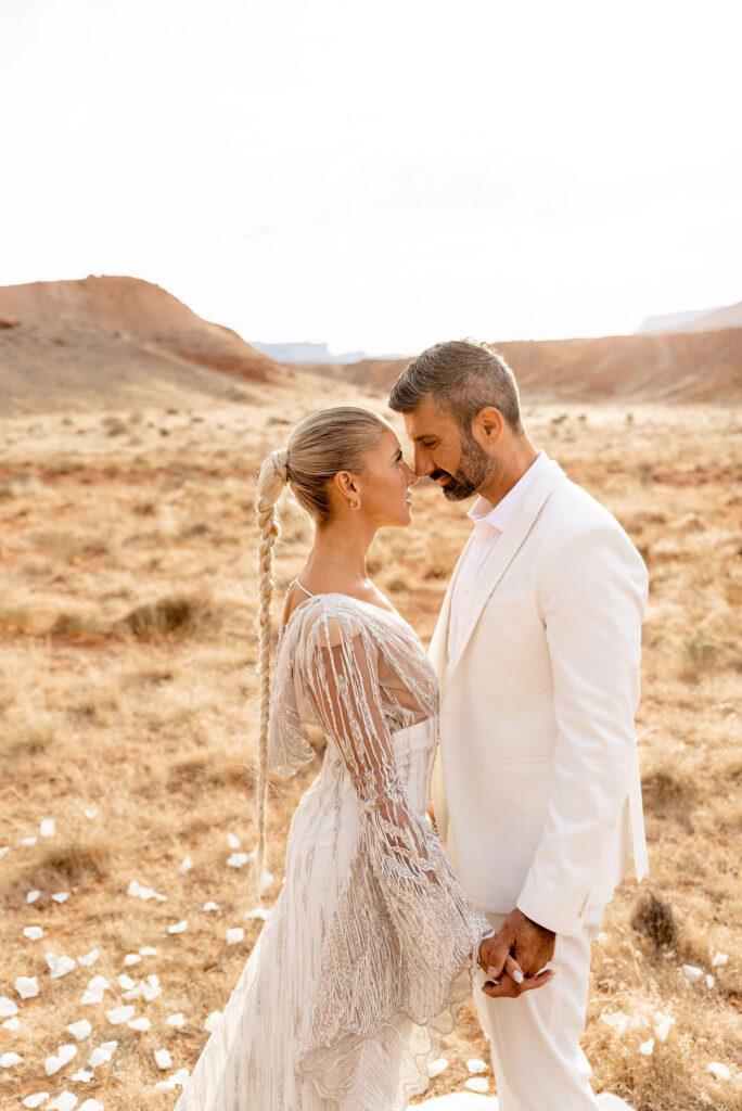 Utah elopement photographer captures couple forehead to forehead during sunrise bridal portraits