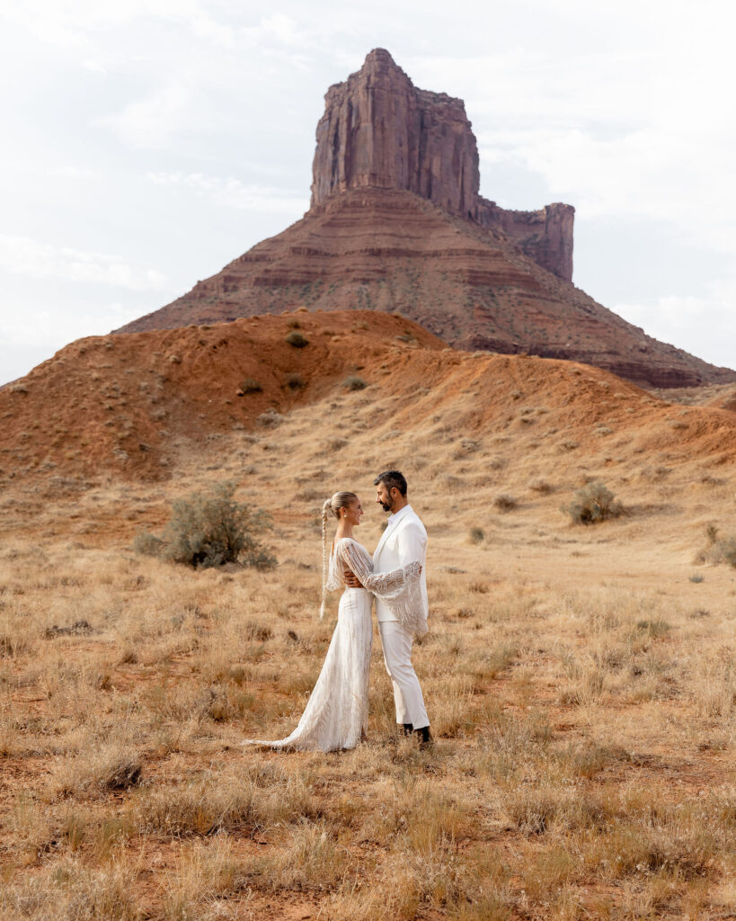newly married couple embracing during bridal portraits in moab