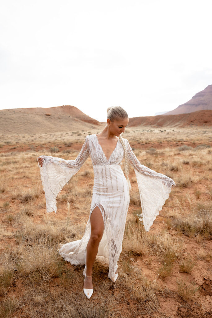 bride wearing lace bell sleeved wedding dress at moab elopement