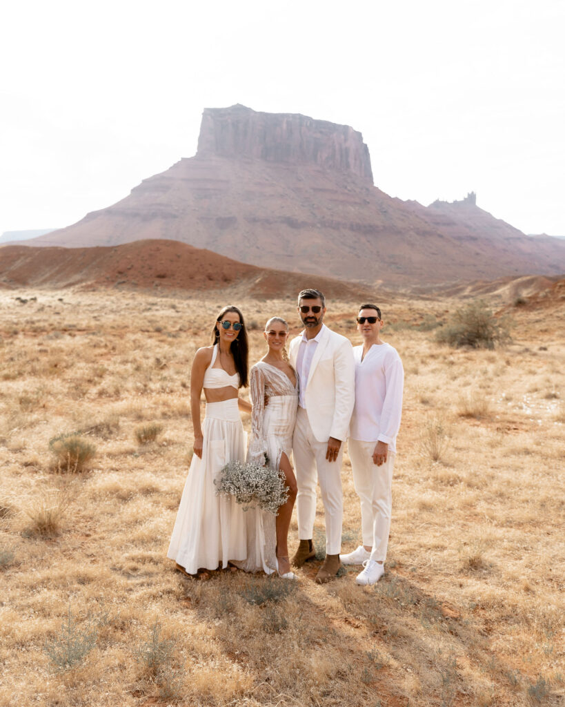 Utah elopement photographer captures bride and groom standing with friends after ceremony