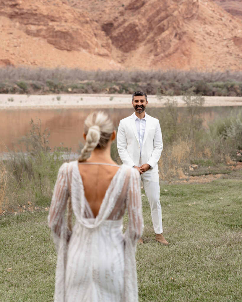 Moab elopement photographer captures groom seeing bride for first time on wedding day during first look