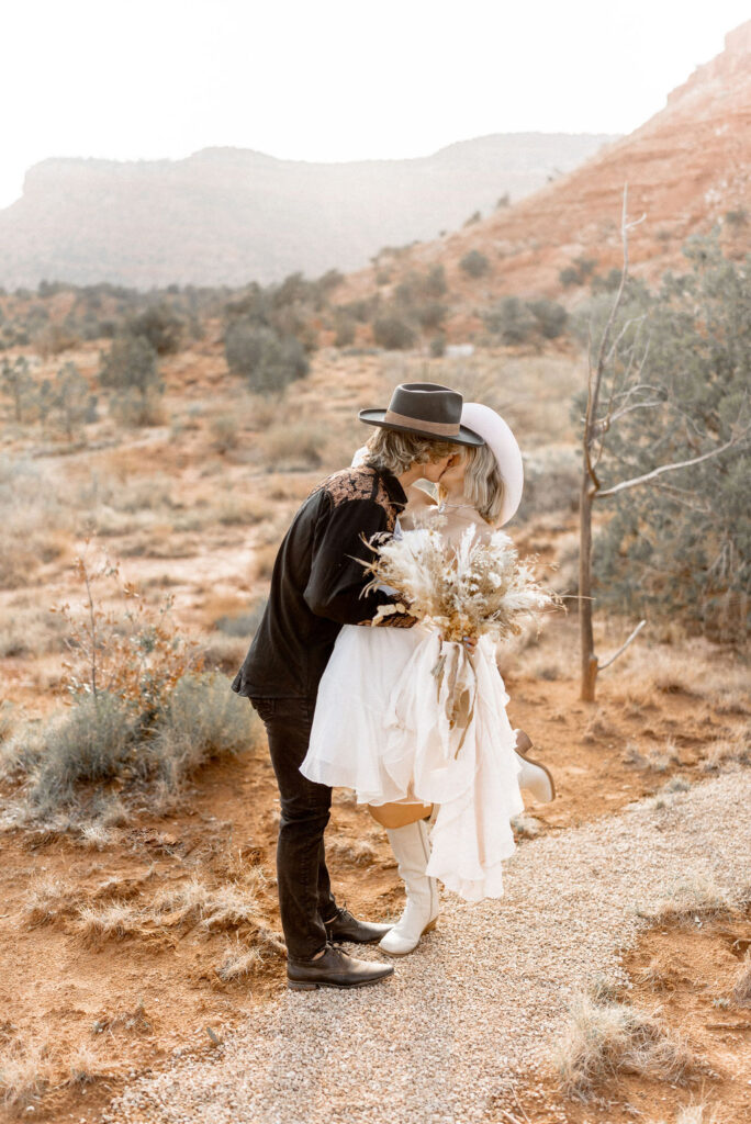 Utah elopement photographer captures groom kissing bride in Kanab