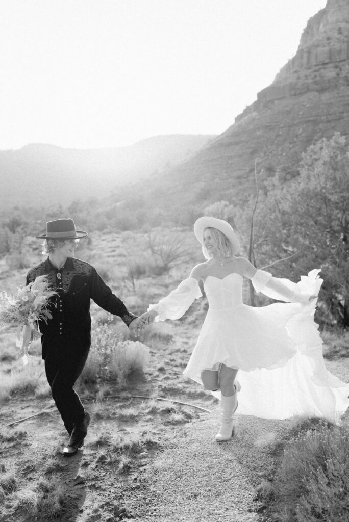 Utah elopement photographer captures bride and groom running away together after elopement