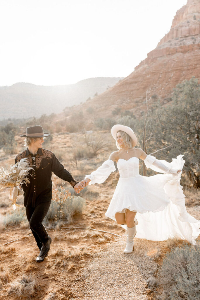 Utah elopement photographer captures couple running through Kanab after elopement