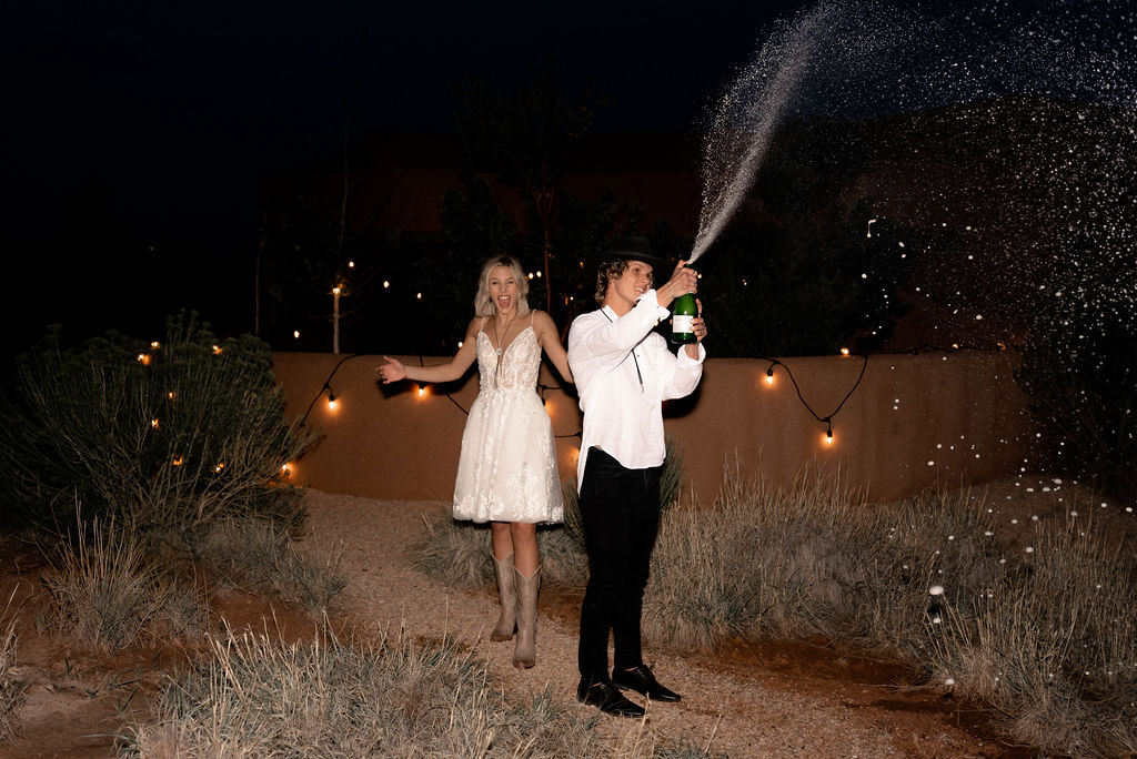 Utah elopement photographer captures couple celebrating with champagne pop