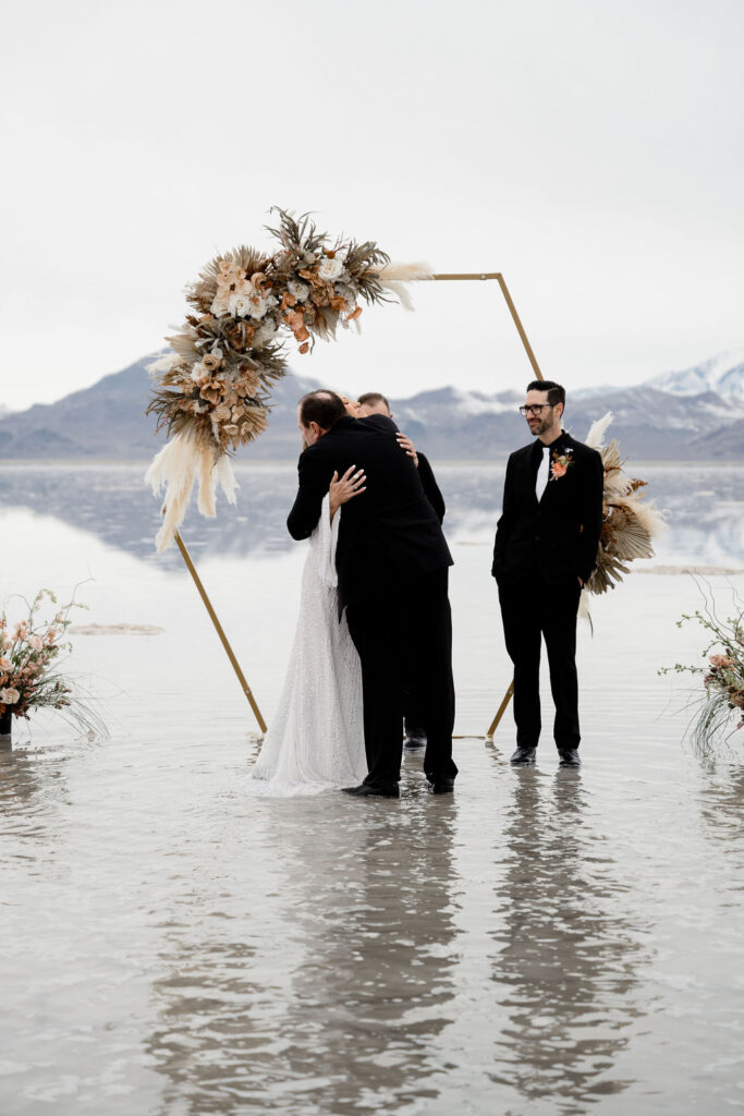 Utah elopement photographer captures bride's father hugging her after walking down the aisle