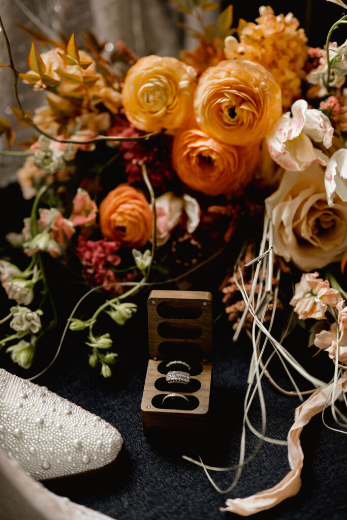 Utah elopement photographer captures terracotta colored bridal bouquet with wedding rings and engagement rings