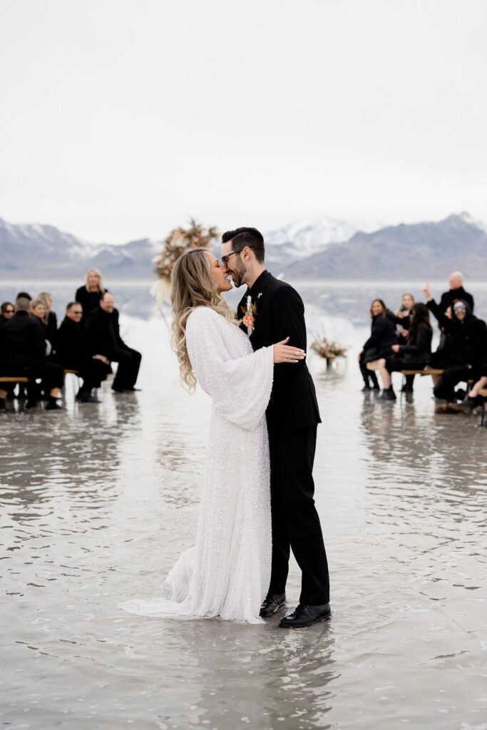 Utah elopement photographer captures couple kissing after bonneville salt flats wedding ceremony