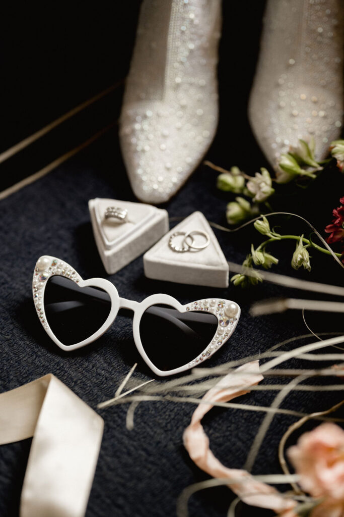Utah elopement photographer captures bridal details with heart shaped sunglasses, and white boots