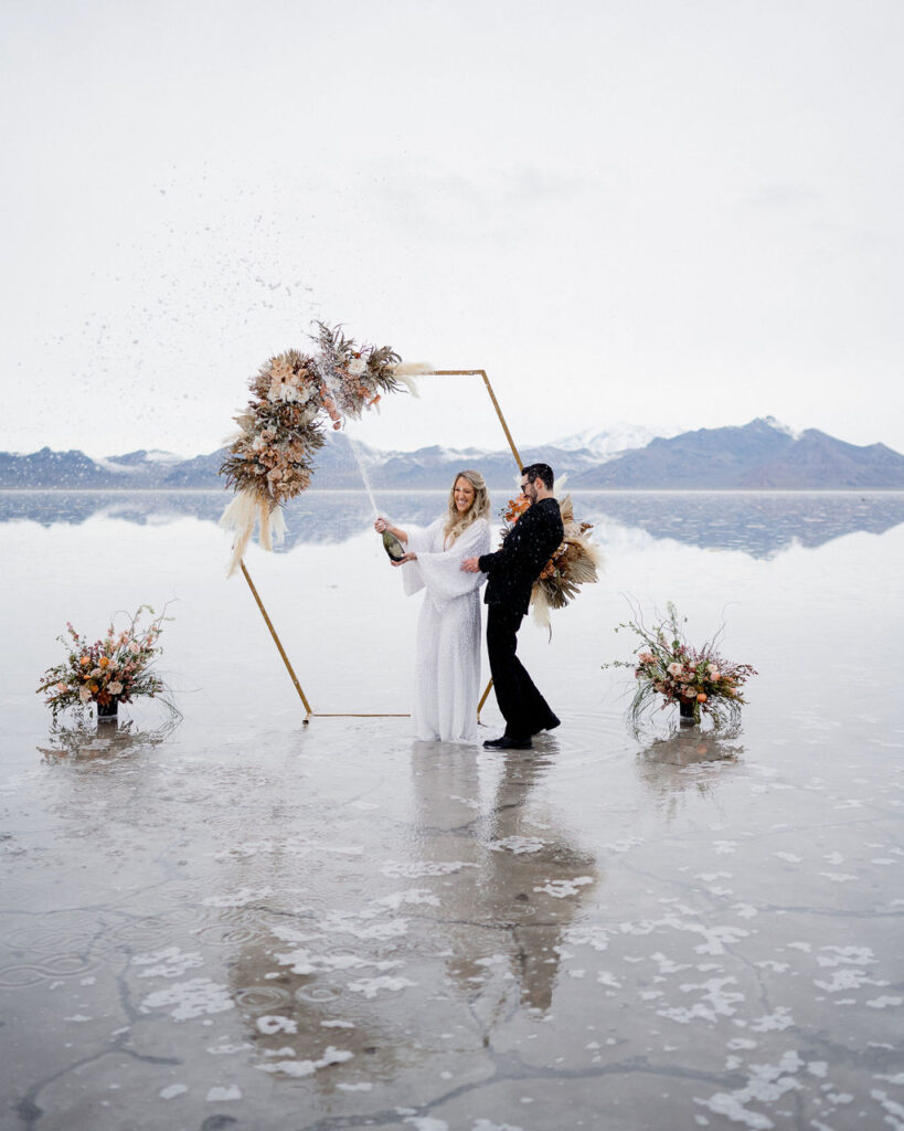 Utah elopement photographer captures couple popping champagne celebrating