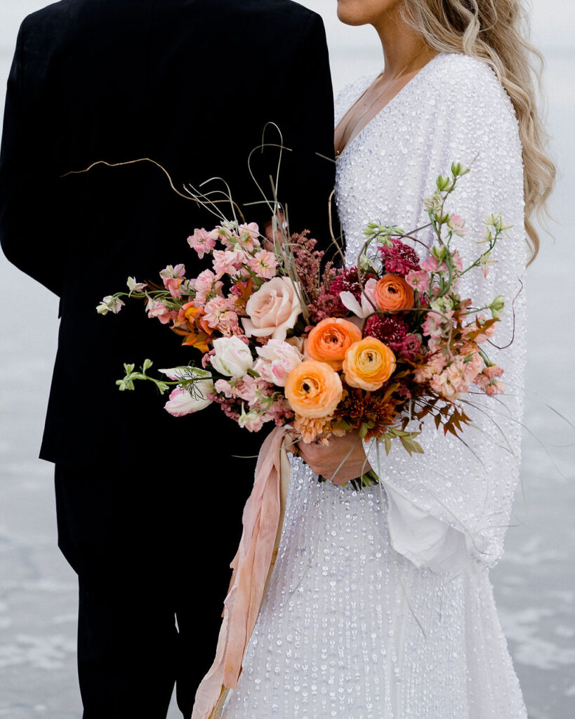 Utah elopement photographer captures couple together holding bridal bouquet