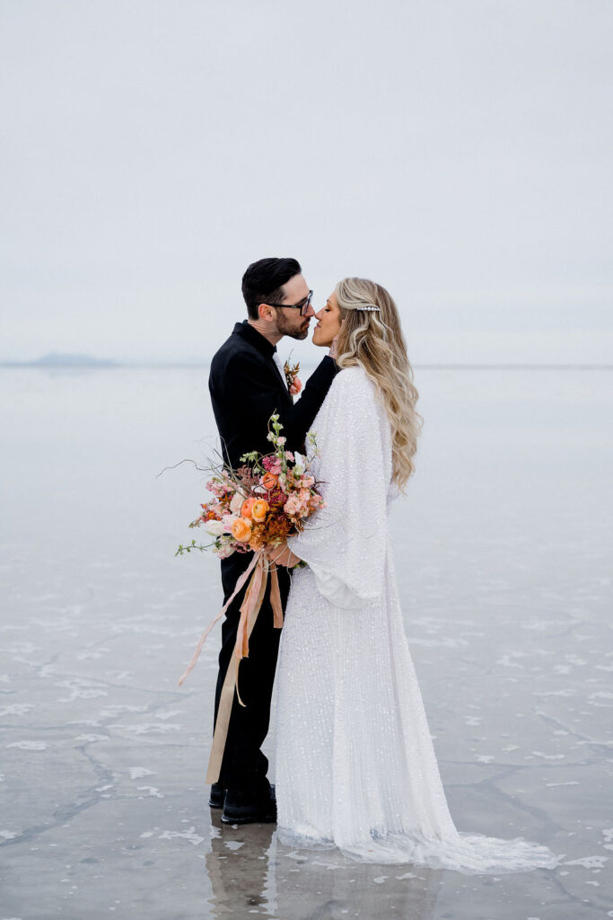 utah elopement photographer captures couple kissing after bonneville salt flats wedding