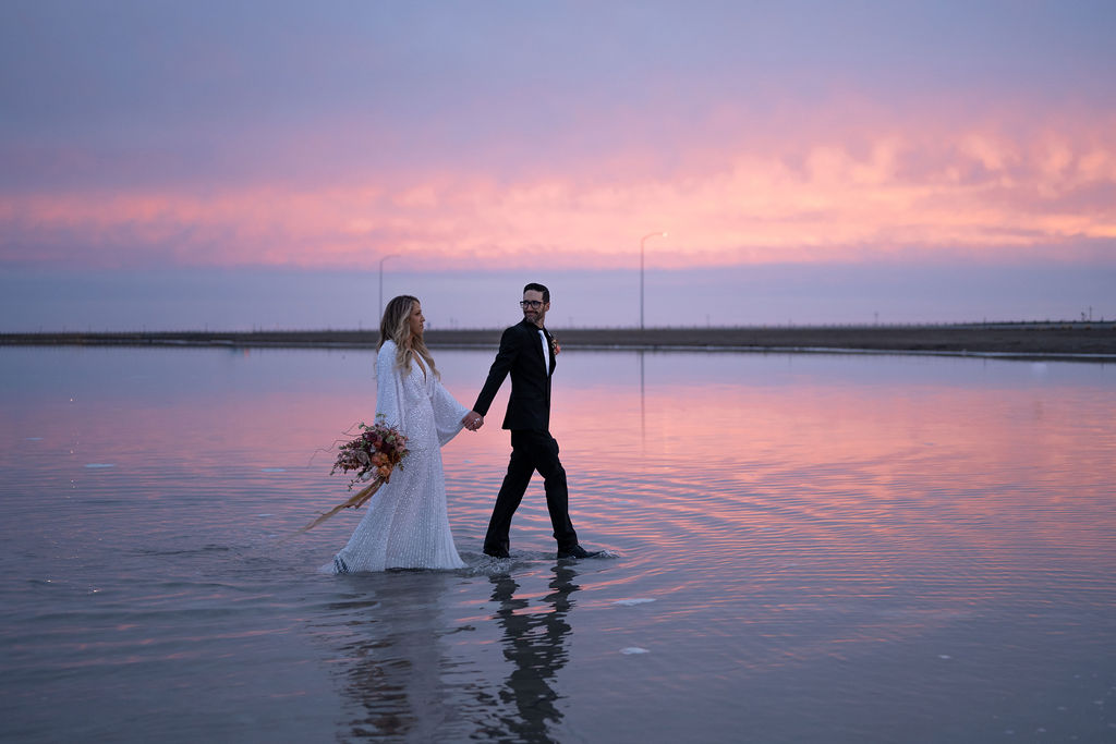Utah elopement photographer captures groom holding bride's hand 