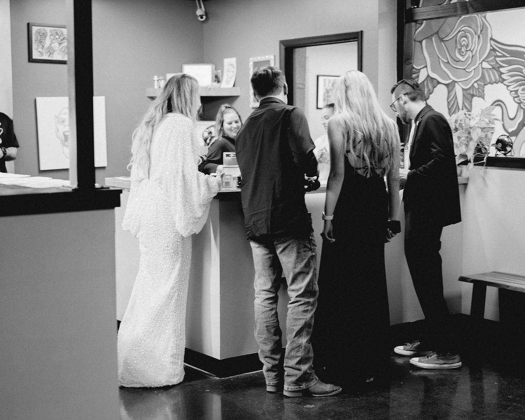 Utah elopement photographer captures couple and wedding party at tattoo shop