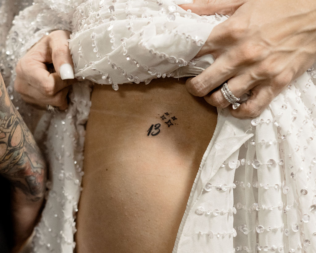 bride showing tattoo after bonneville salt flats wedding ceremony