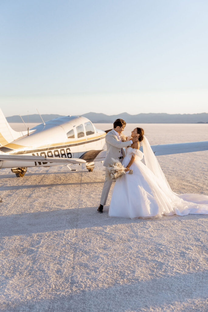 Utah elopement photographer captures bride and groom in front of airplane
