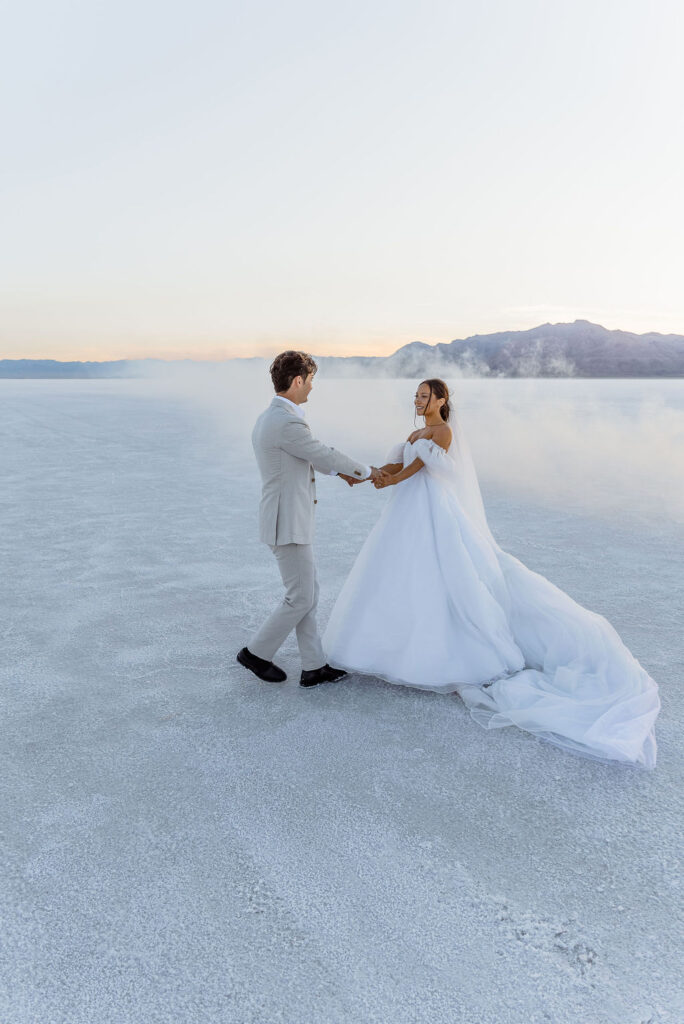 Utah elopement photographer captures couple spinning together at Salt Flats