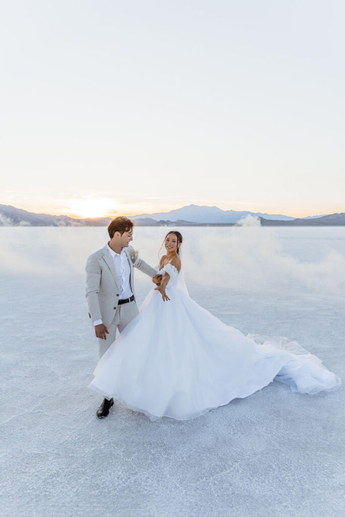 Utah elopement photographer captures bride and groom dancing on Salt Flats