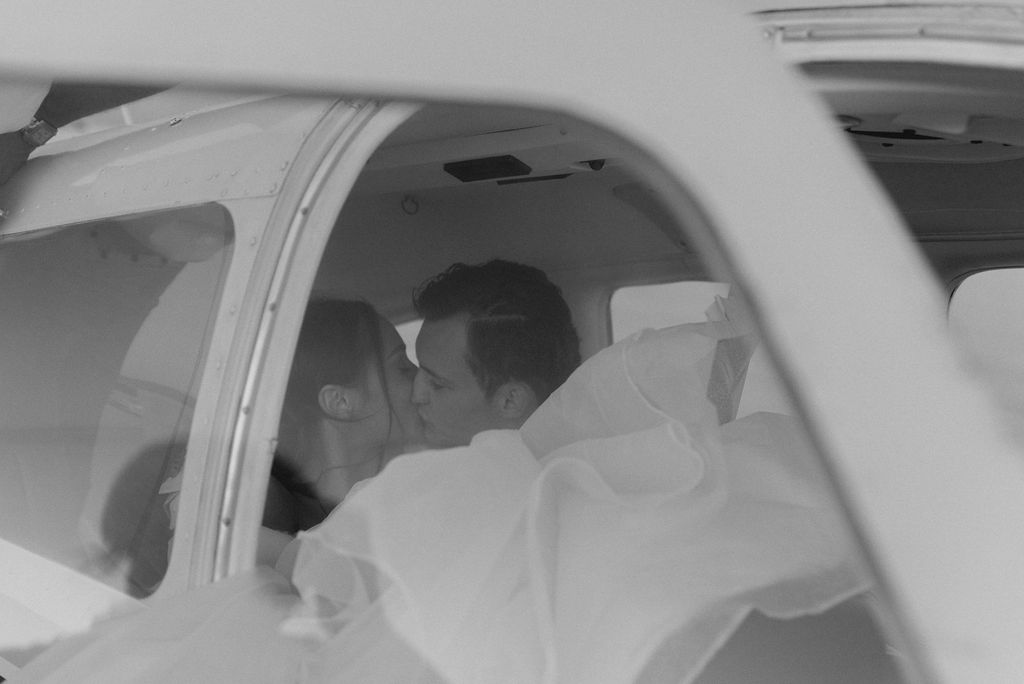 Utah elopement photographer captures couple kissing in airplane before they left