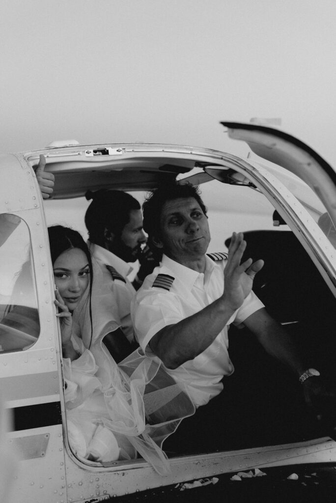 Utah elopement photographer captures couple leaving plane with bride's father