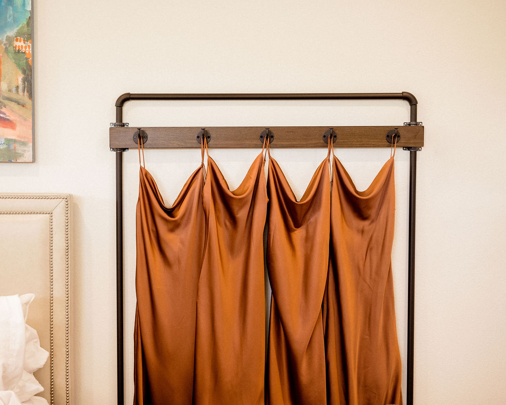 Utah elopement photographer captures rust orange bridesmaid dresses hanging 