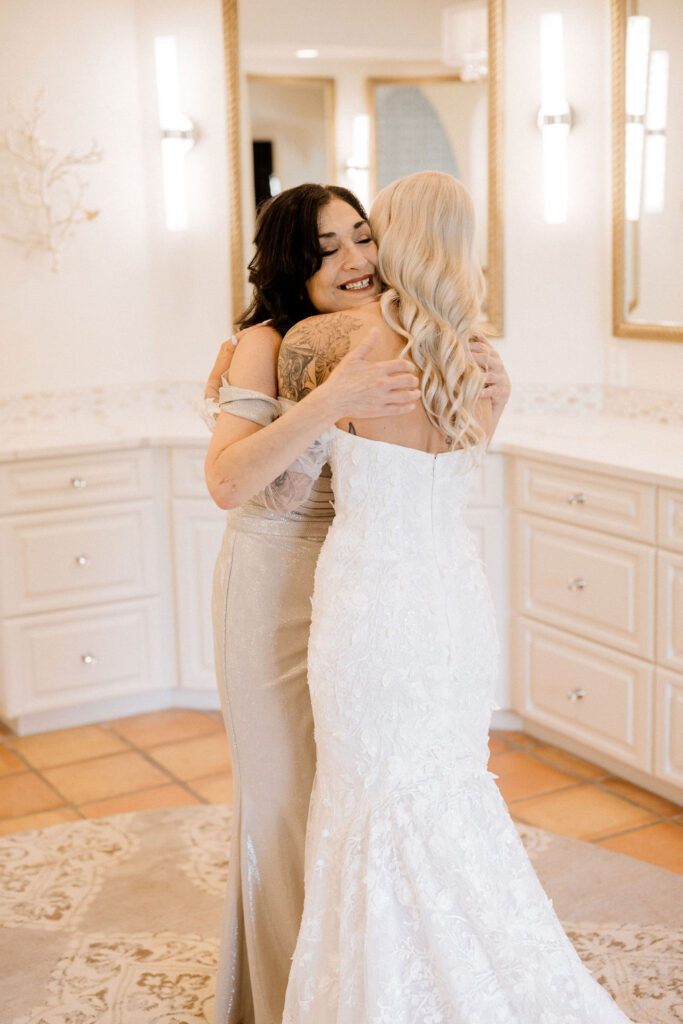 Utah elopement photographer captures bride hugging mother on Zion National Park wedding