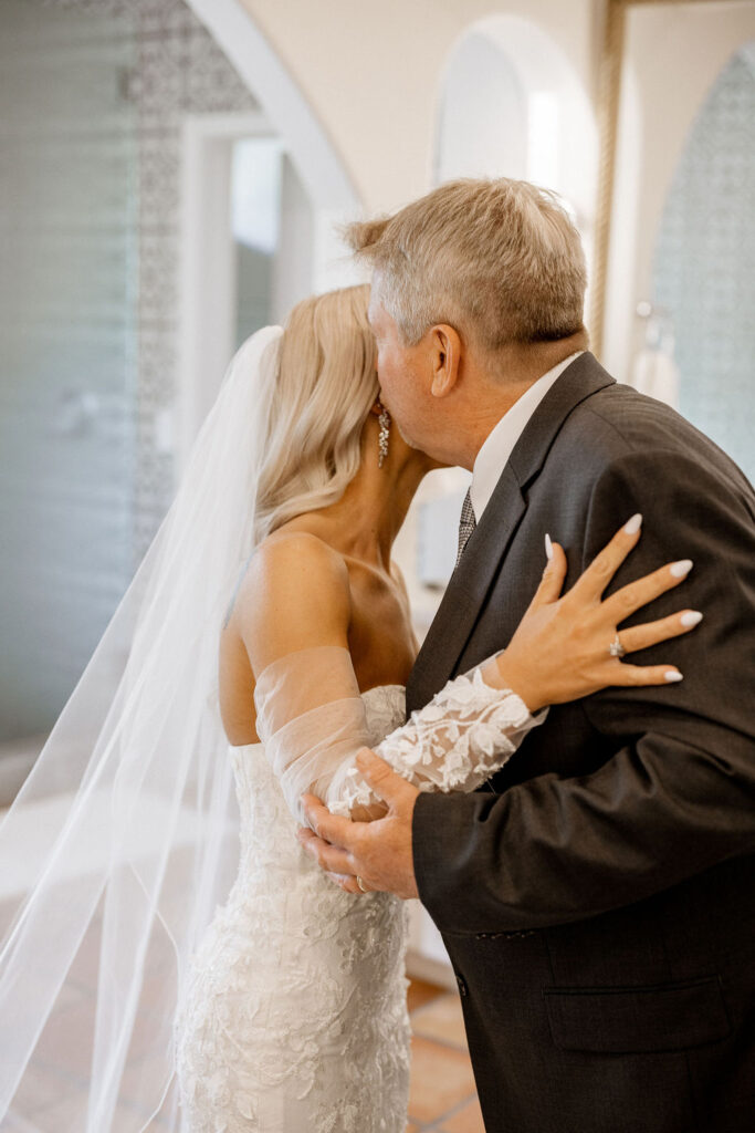 Utah elopement photographer captures bride kissing father's cheek after first look