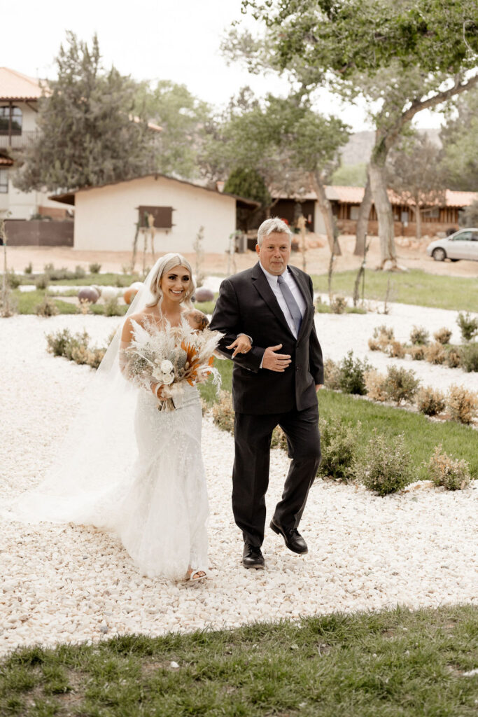 Utah elopement photographer captures bride walking down aisle with father 