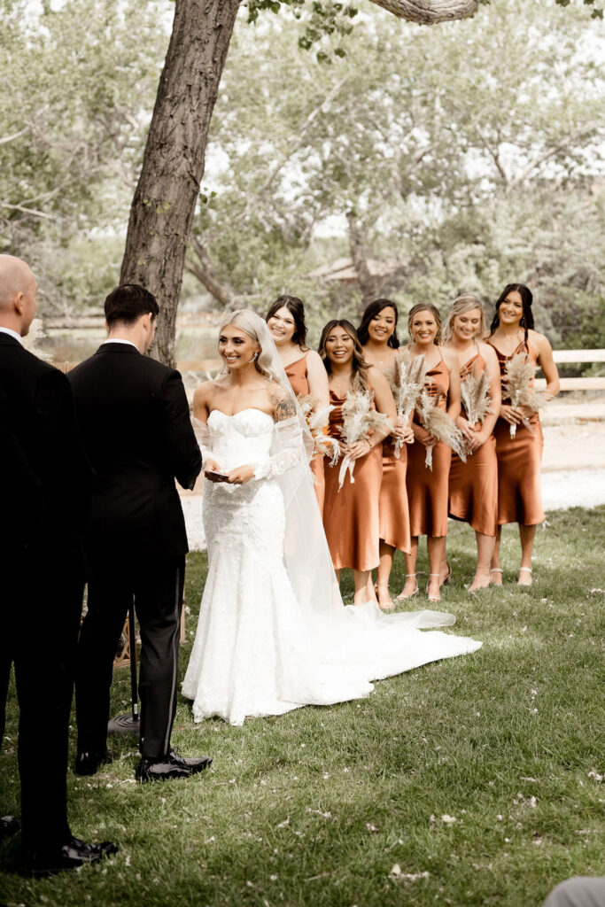 Utah elopement photographer captures bride looking at groom while reading his vows