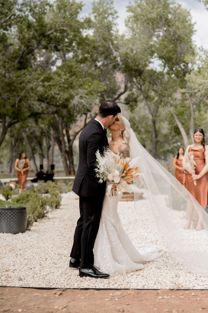 Utah elopement photographer captures bride and groom kissing during outdoor bridals