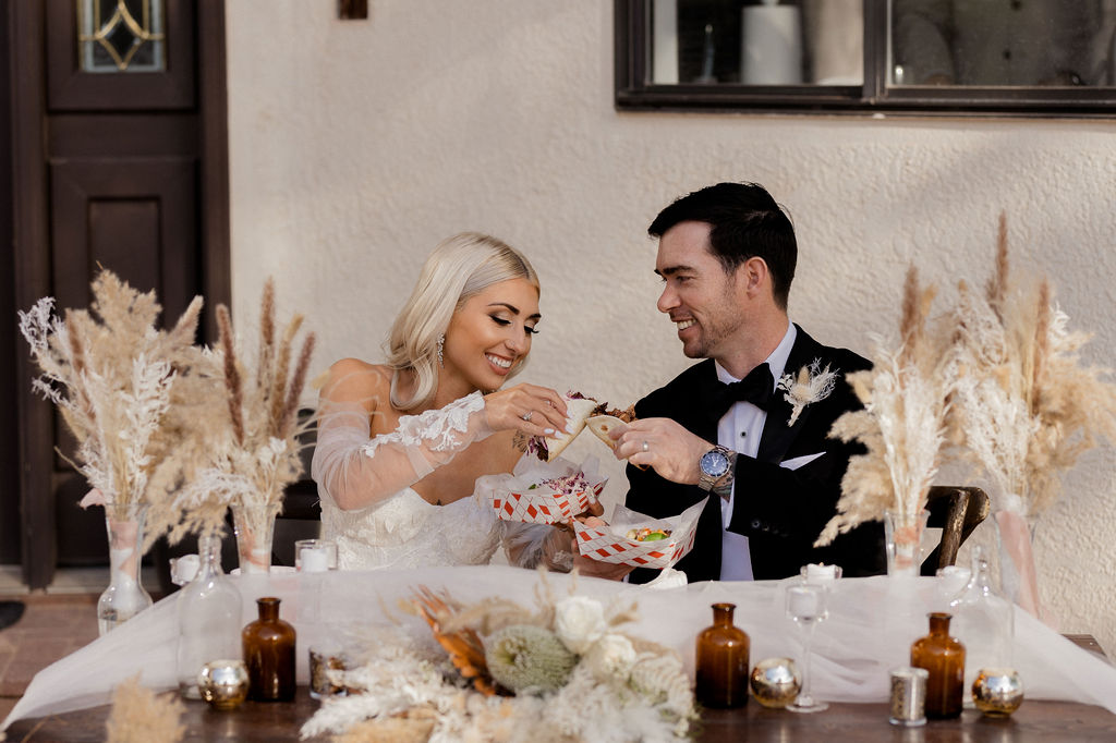 Utah elopement photographer captures bride and groom eating reception dinner