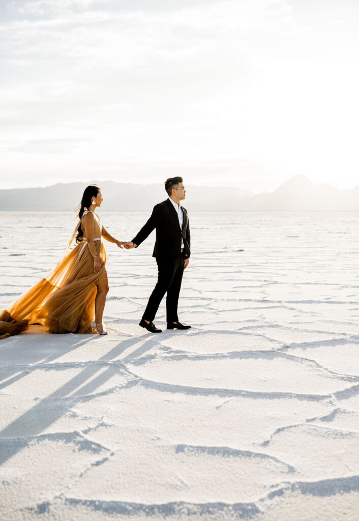 Utah elopement photographer captures couple walking on Salt Flats 