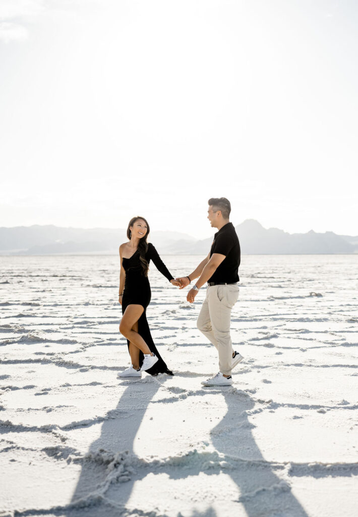 Utah elopement photographer captures couple walking wearing black and white outfits