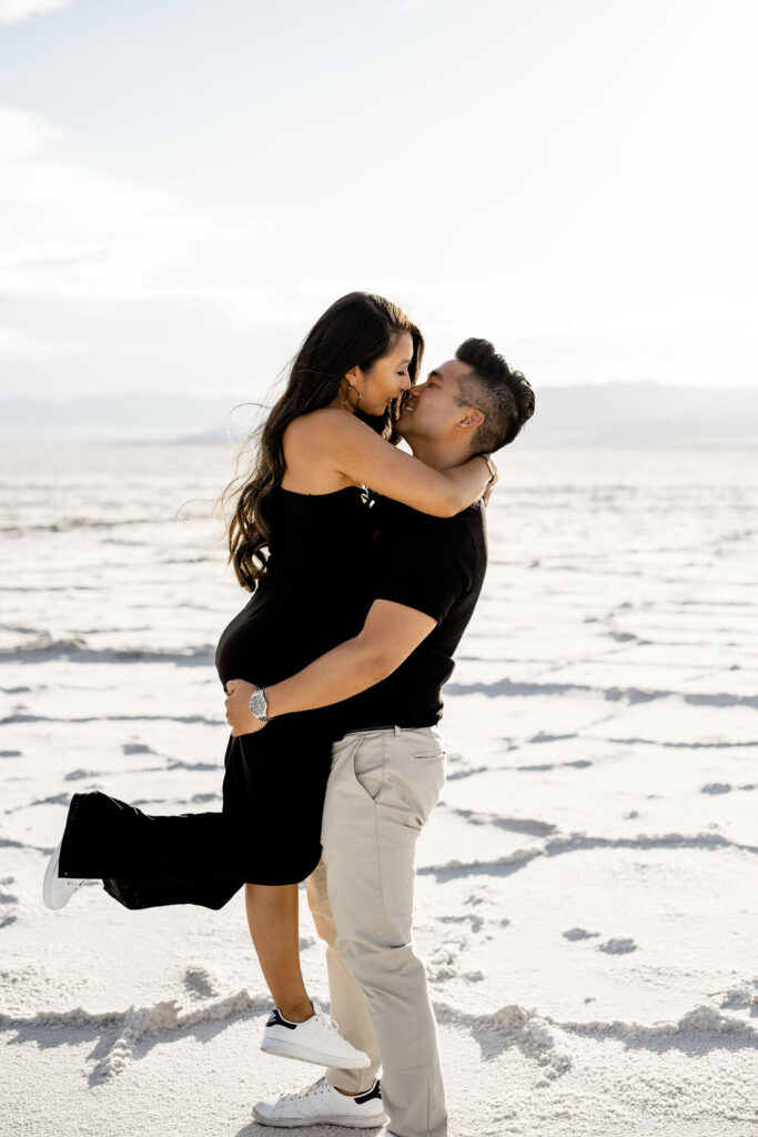 Utah elopement photographer captures man lifting woman off ground and kissing her