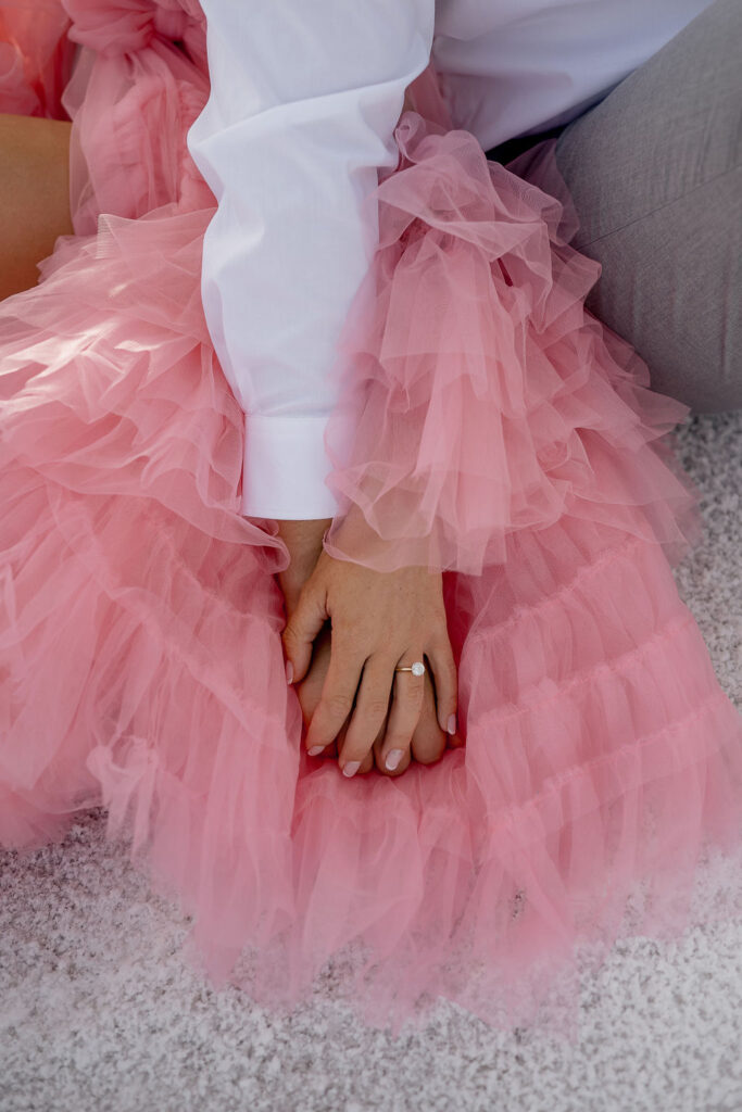 Utah elopement photographer captures couple holding hands on pink dress