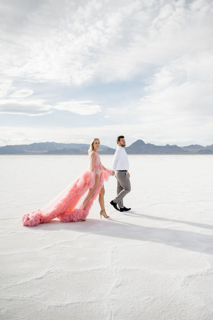 Utah elopement photographer captures couple holding hands and walking together 