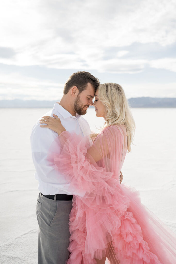 Utah elopement photographer captures couple forehead to forehead during salt flats engagements