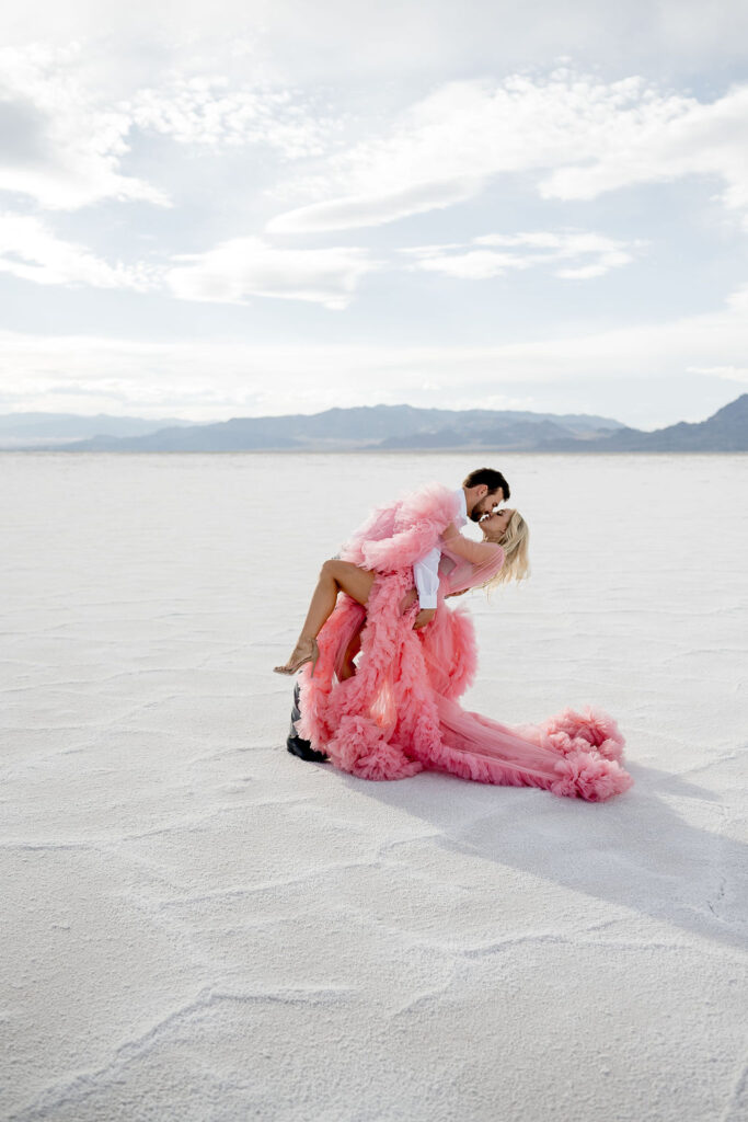 Utah elopement photographer captures couple dip kiss during salt flats engagements