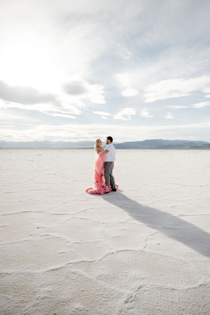Utah elopement photographer captures couple walking together during Salt Flats engagements