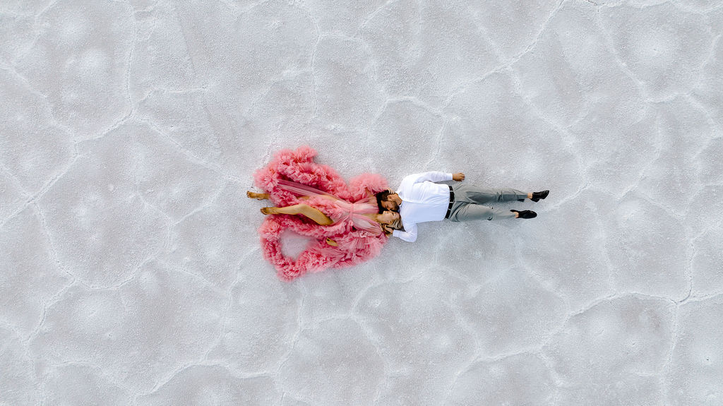 Utah elopement photographer captures couple laying on Salt Flats during engagements