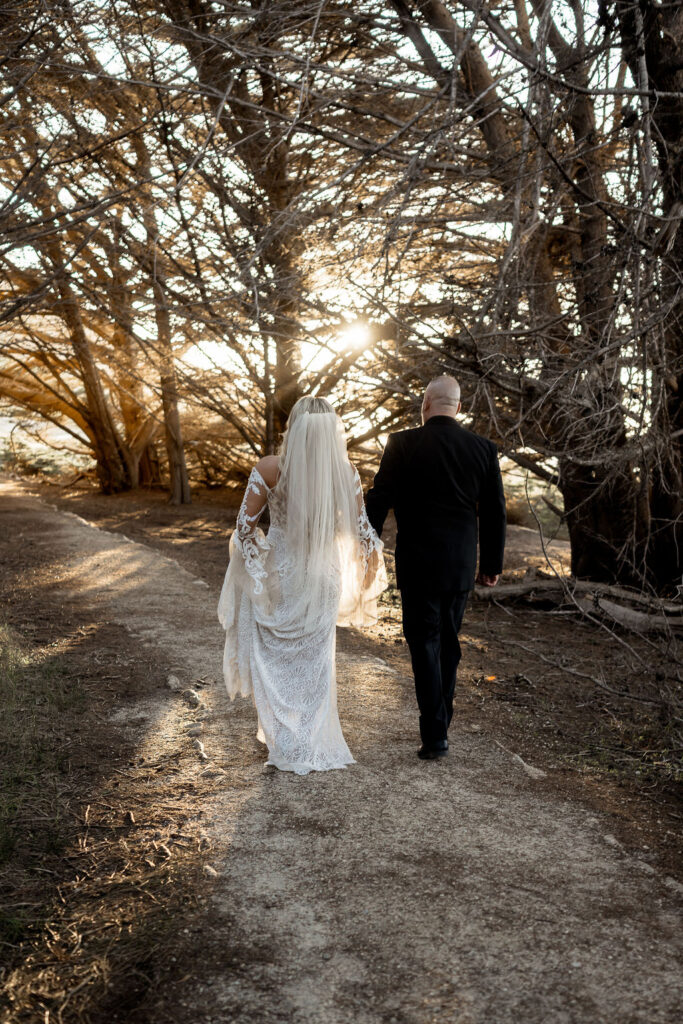 Big Sur elopement photographer captures couple walking through Redwoods 