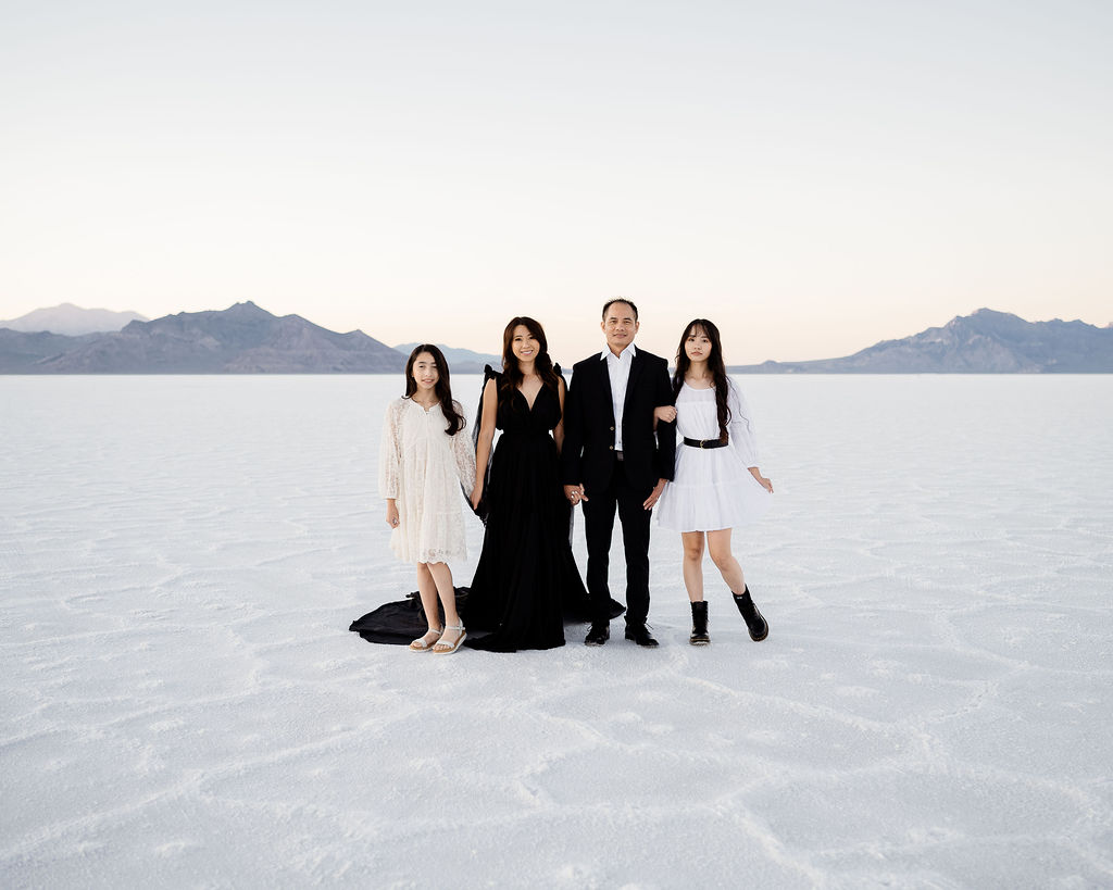 family photos at sunset at the salt flats in black and white dresses and suits
