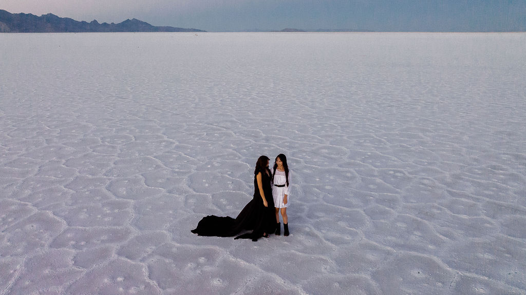 mother and daughter at salt flats at blue hour - drone photo