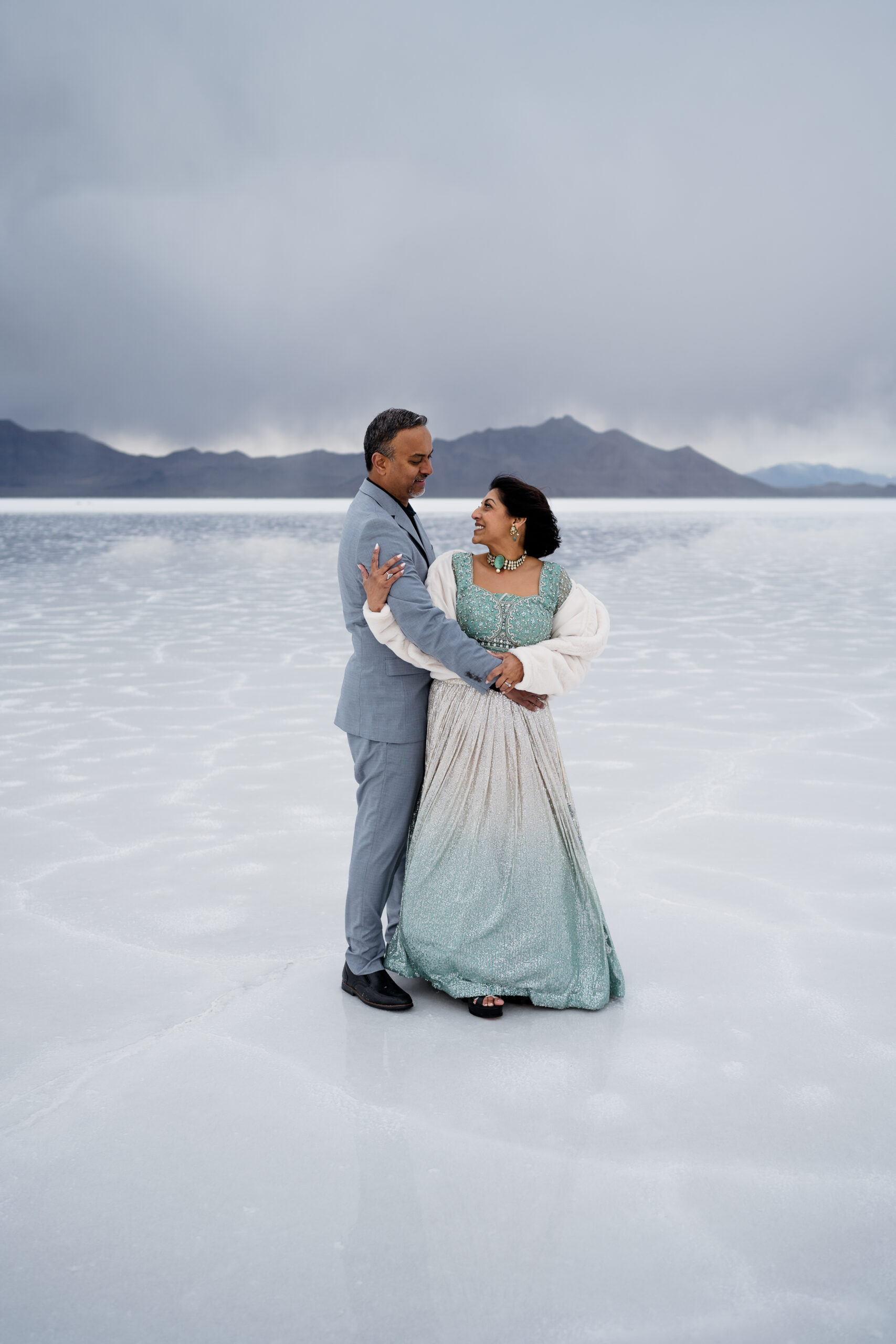 Rare flooded bonneville salt flats couple holding each other in formal attire